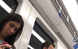 Sexy brunette in flip flops in subway candid