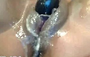 Stunning ebony toys her swollen pussy and squirts