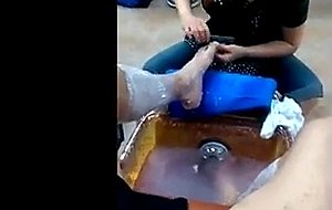 Pedicurist shyly peeks at jerking  cumming male client