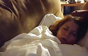 Son playing with sleeping mother