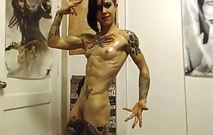 Ripped goth babe oils her muscles  