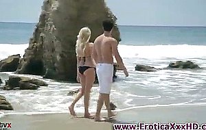 Sexy blonde frolicking on the beach
