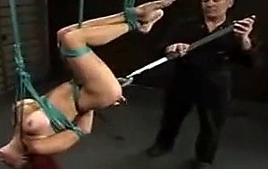 In a cold lonely factory a young bondage slut is ...