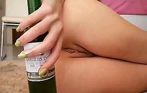 Blond wife stretching her ass with a bottle 