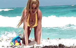 Latin shemale in yellow bikini at beach masturbating in the ocean