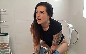 Sexy tattooed brunette shitting on camera