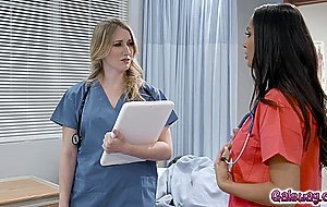 Riley and Sofi tumble into bed together and peel away their scrubs