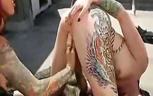 Two tattooed babes play together