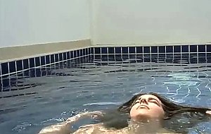 Beautiful girl shows her charms in the pool