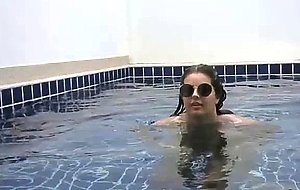 Beautiful girl shows her charms in the pool