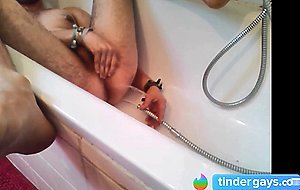 Bi-guy using shower head, squirting water, enema