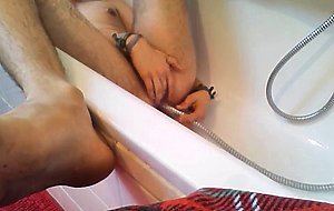 Bi-guy using shower head, squirting water, enema