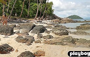 Petite Asian teen model posed on the beach and revealed her stunning body