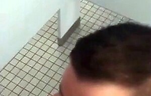 Handsome guy sucks dick in restroom stall