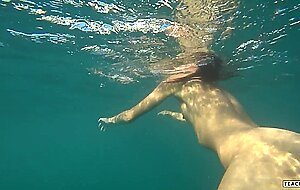 Goldteachers, naked model swims on a public beach in ru