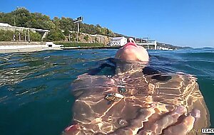 Goldteachers, naked model swims on a public beach in ru