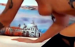 Latina babe with tattoo fingering herself