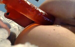 girl takes a big toy up the butt...