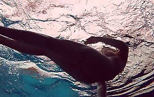 Hot tatted babe Dashka has big tits swirling underwater