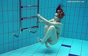 Hot tatted babe Dashka has big tits swirling underwater