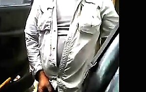 Bearded daddy strokes his cock by his truck outdoors.