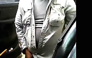 Bearded daddy strokes his cock by his truck outdoors.