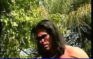 Busty black whore milking dick in garden