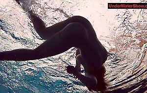 Tattooed baby swirls underwater