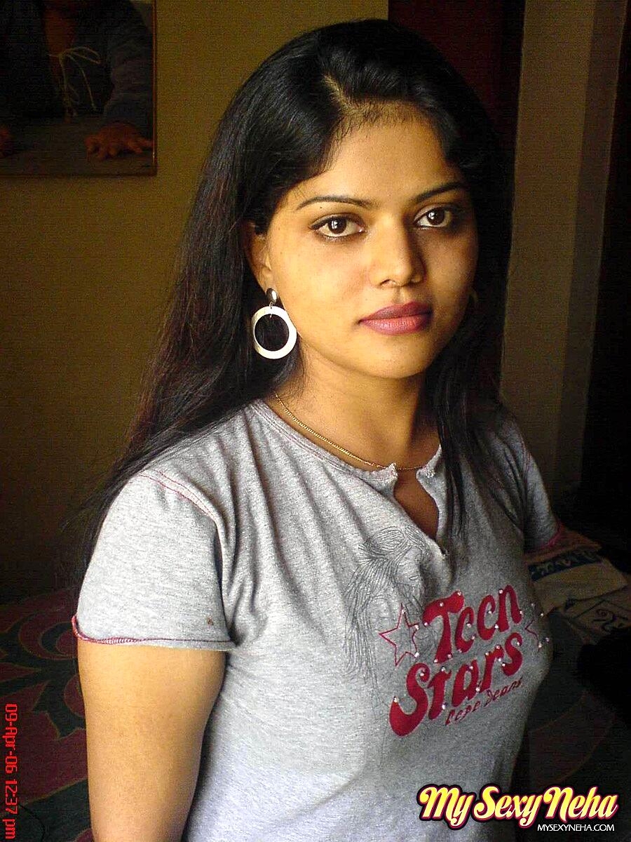 Petite Indian girl uncups big naturals after removing blue jeans
