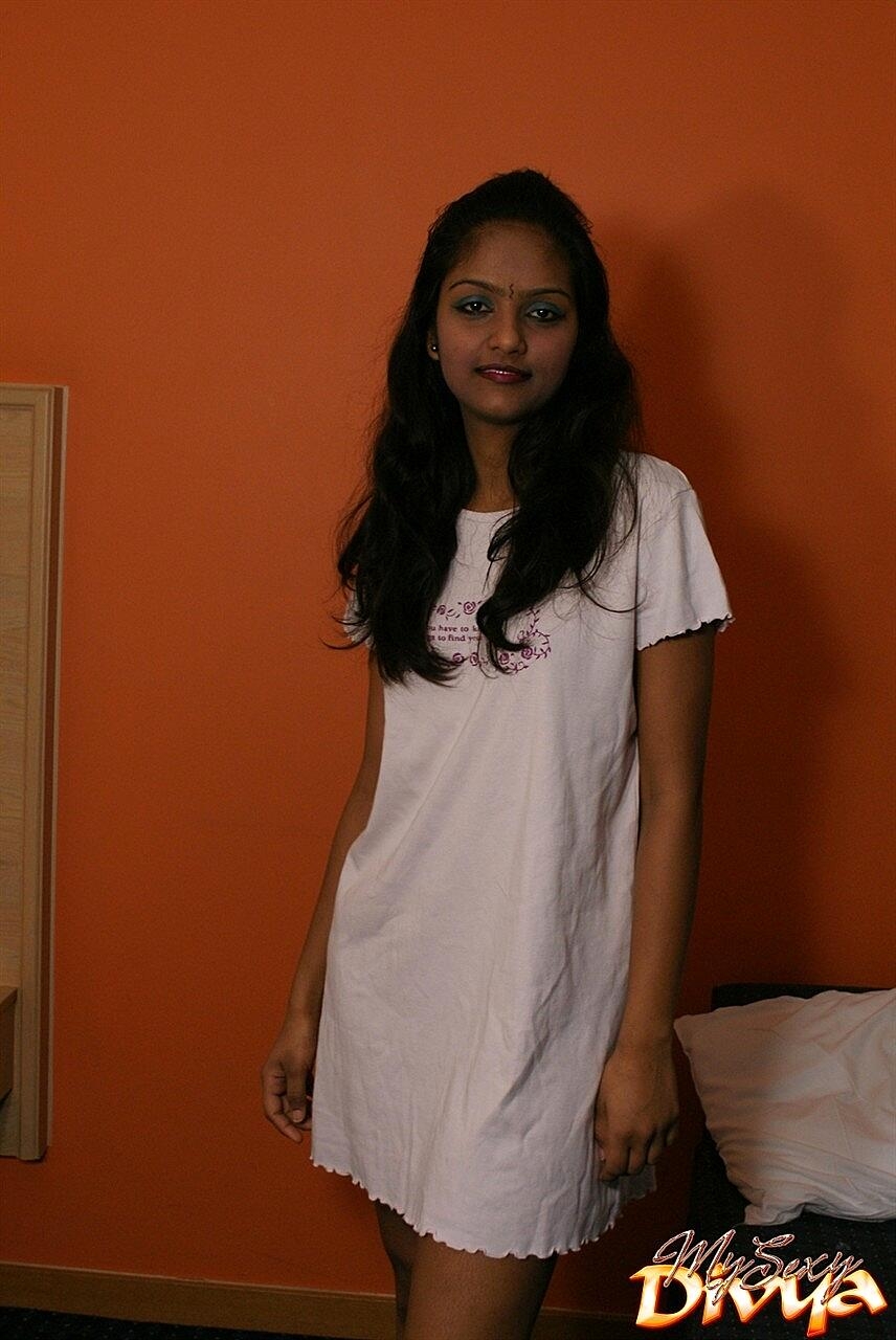 Indian female Divya lifts up a white dress to expose her vagina