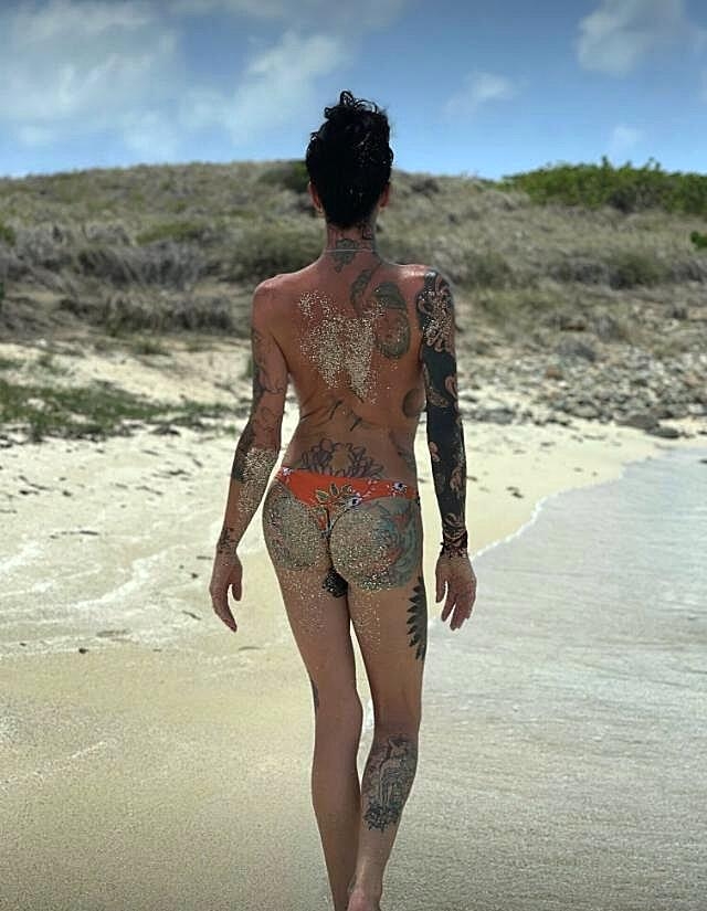 Naughty brunette Morgan Bailey shows her tattoos outdoors while topless