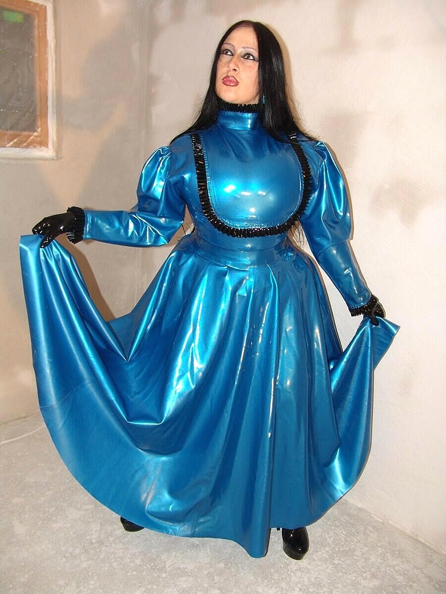Dark-haired chick Lady Angelina models an amazing latex dress during a SFW gig